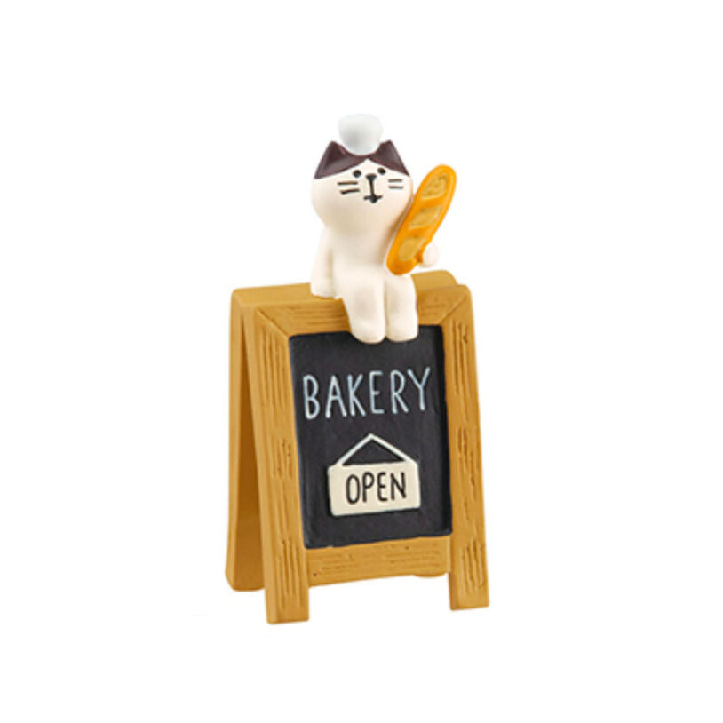 cat sitting on the bread sign